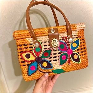 Straw woven basket with flowers and butterflies